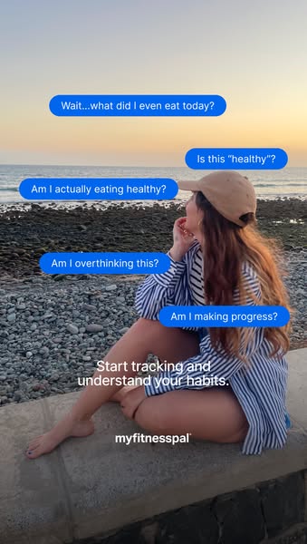 An ad for MyFitnessPal, a fitness tracking app, features a woman sitting on a stone wall overlooking the ocean. Text bub