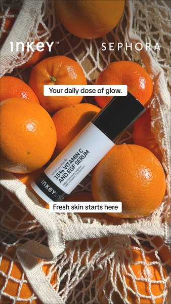 This image ad for The Inkey List's 15% Vitamin C and EGF Serum features the product placed among oranges in a net ba