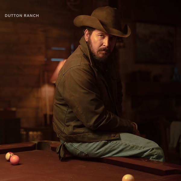 This is a still image ad for Dutton Ranch, featuring an actor in a cowboy hat and jacket sitting on a pool table.