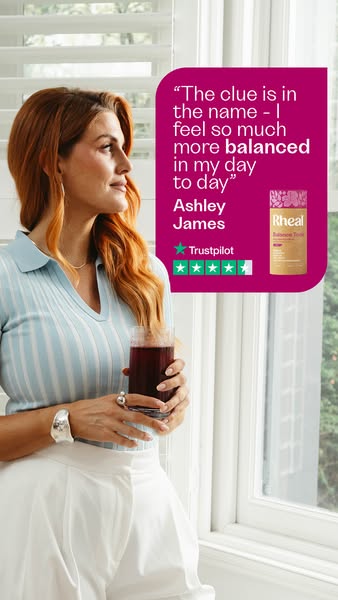 This image ad shows a woman in front of a window holding a glass of a purple liquid, with a magenta box containing a quo