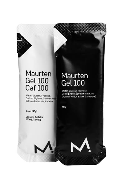 A product shot featuring two energy gels, one black and one white. The shot highlights the ingredients of the gels.