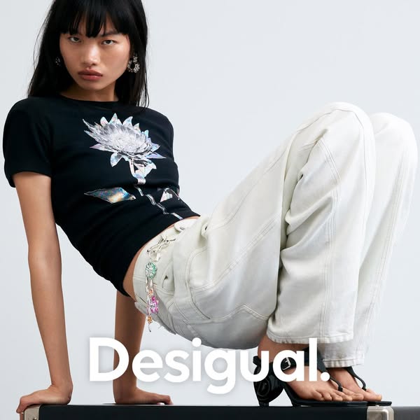 This ad from Desigual features an Asian model wearing a black t-shirt with a flower graphic, along with a pair of light 