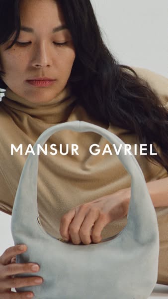 This image ad features a woman holding a Mansur Gavriel bag. The ad emphasizes the brand's name and the bag's de