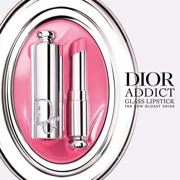 The ad showcases DIOR Addict Glass Lipstick. The advertisement features a highly polished studio shot with a light pink 