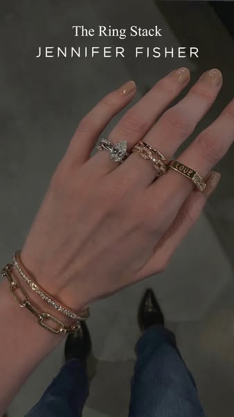 This image ad showcases a variety of rings and bracelets from Jennifer Fisher. The ad focuses on 'The Ring Stack'