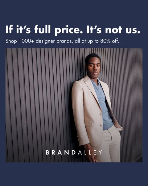 This image ad for BrandAlley features a man in a tan suit leaning against a grey slat wall. The ad headline claims that 