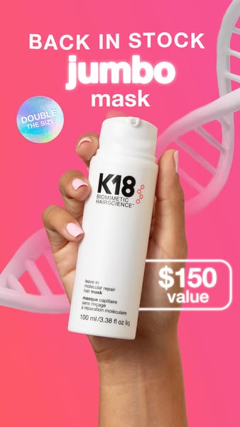 This image ad promotes K18's jumbo-sized hair mask as being back in stock. It shows the product in someone's han