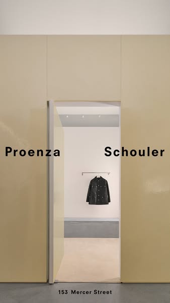 This ad for Proenza Schouler features a jacket hanging in an open doorway of their retail store. The brand name is writt
