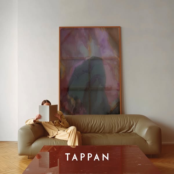 This ad features a photograph of a person reading a book on a sofa in a living room with an abstract art piece in the ba
