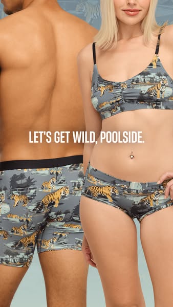 An ad showing a man and a woman wearing matching underwear. The underwear has a tiger and tropical themed design. The ad