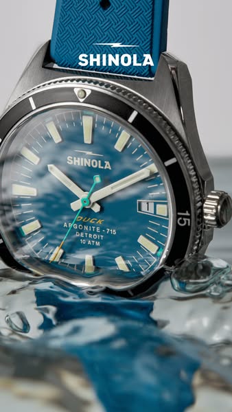 The ad features a Shinola watch in a pool of water, emphasizing its durability and craftsmanship.
