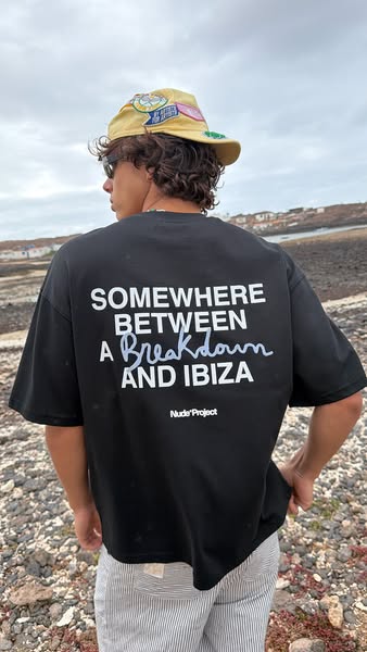 This image ad features a person standing outdoors wearing a t-shirt branded with the text 'Somewhere Between A Break