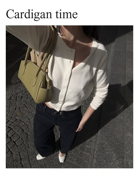 Aesthetic image showcasing the promoted cream cardigan being worn outdoors with accompanying stylish accessories.