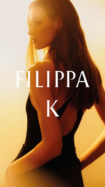 This image ad features a fashionable woman wearing a black, low-back dress. The focus is on the design and the brand pos