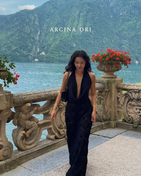 This ad features a woman in a black dress in front of a landscape, promoting the clothing brand Arcina Ori.