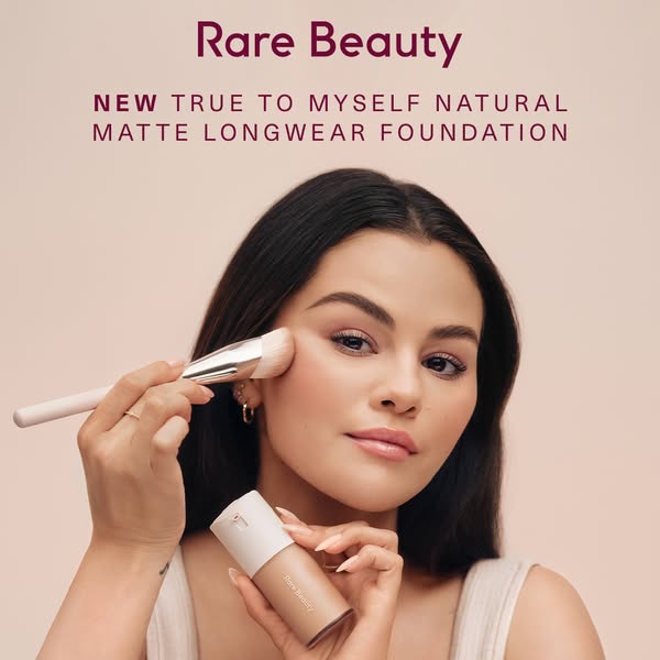 An ad for Rare Beauty's NEW True to Myself Natural Matte Longwear Foundation. The ad features Selena Gomez applying 