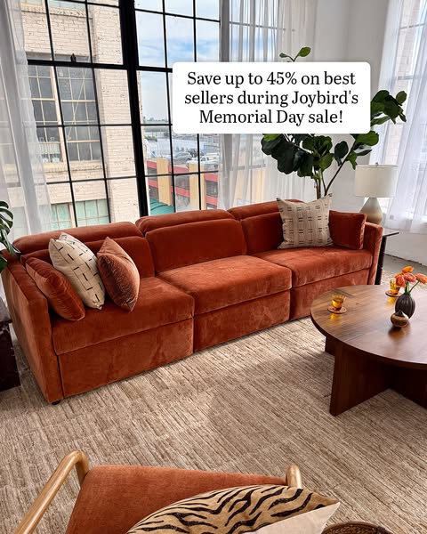 This ad features a living room setup with a large, orange sectional sofa as the focal point. The ad promotes a sale on b