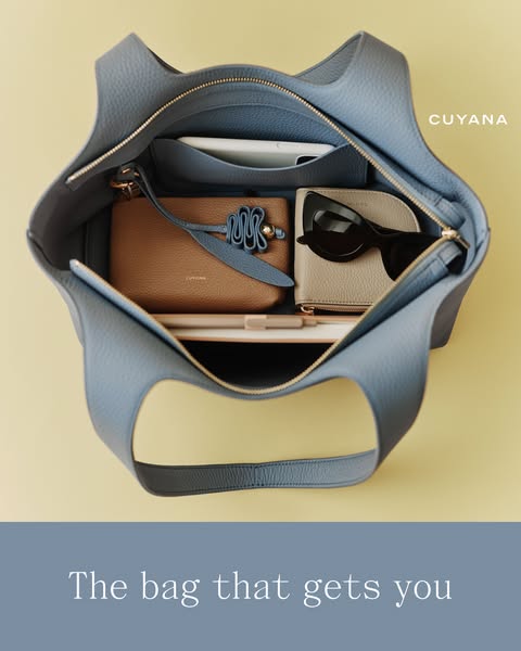 An image ad showcasing a Cuyana tote bag, focusing on its organizational capabilities and stylish design.