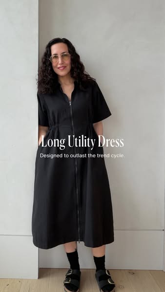 This image ad features a woman posing in a long black utility dress from the featured brand. The ad emphasizes the dress