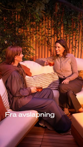 This ad shows two women sitting on an outdoor couch, each holding a drink, with the headline "Fra avslapning."