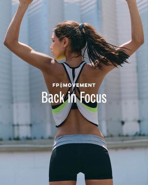 This image ad showcases FP Movement activewear apparel. The ad features a woman from the back, wearing a sports bra and 
