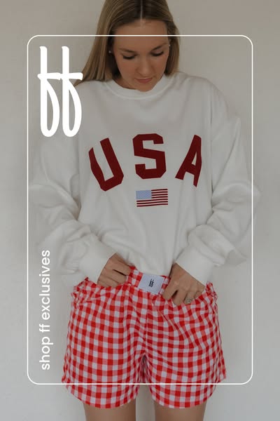 This image ad features a woman wearing a sweatshirt and shorts. The ad promotes a pair of red and white gingham shorts.