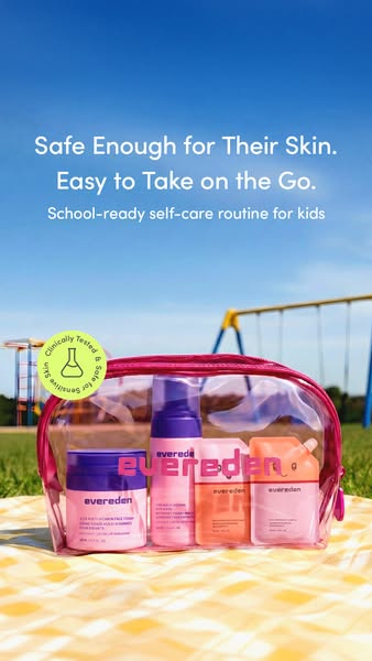 Image ad featuring skincare products inside of a clear pink bag, on top of a yellow patterned blanket. There is a playgr