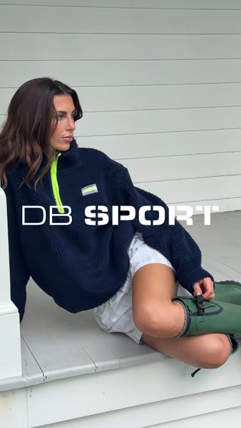 This image ad features a woman modeling a DB Sport quarter-zip sherpa pullover. The ad focuses on visual appeal to draw 