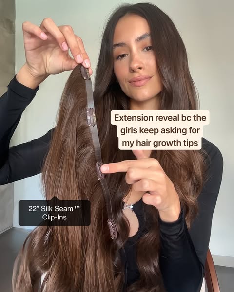 A woman uses hair extensions to add volume and length to her hair, and is sharing her 'hair growth tips' with he