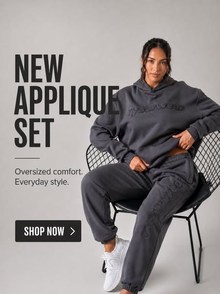 This image ad showcases a woman wearing a dark grey applique set consisting of a hoodie and sweatpants, advertising the 