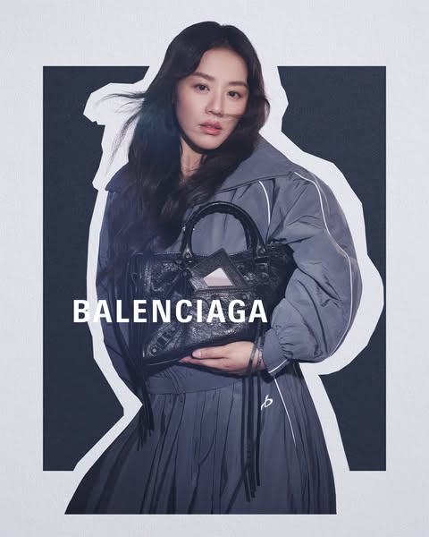 This ad features an Asian woman modeling a Balenciaga handbag and outfit against a geometric monochrome background. The 