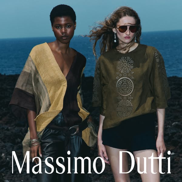 This image ad showcases two models wearing apparel from Massimo Dutti in front of a backdrop of the ocean and a rocky la