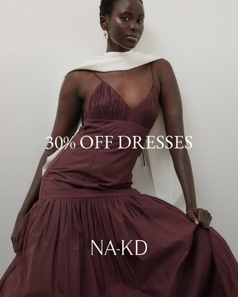 An ad for NA-KD featuring a maroon dress with a special offer of 30% off all dresses.