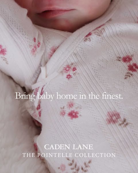 This ad for Caden Lane baby clothing features a close up image of a baby wearing a floral print pointelle outfit. The te