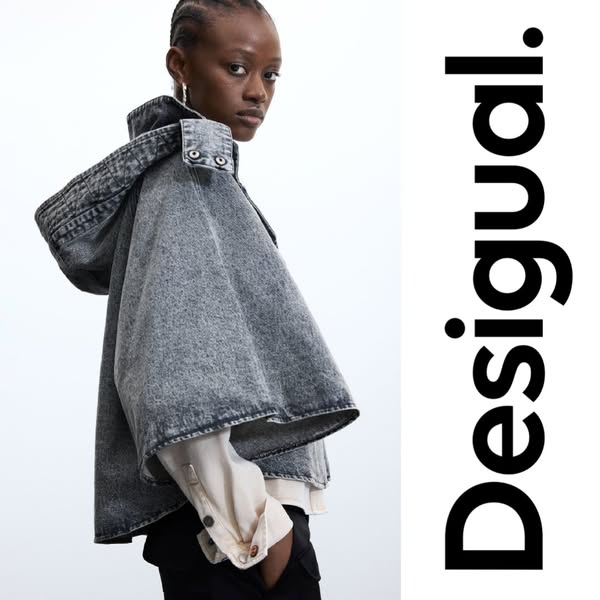 This ad showcases a hooded denim cape by Desigual. The image features a model wearing the cape, set against a bright bac