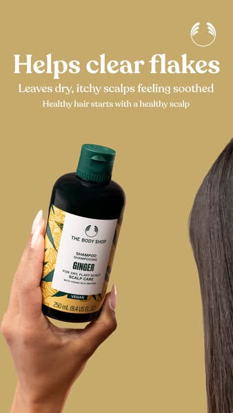 An image ad for The Body Shop's Ginger shampoo. The ad highlights the product's ability to clear flakes and soot