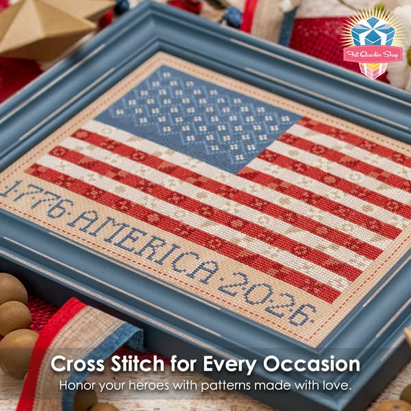 This ad features an image of a cross-stitched American flag in a blue frame. The ad promotes cross-stitch patterns from 