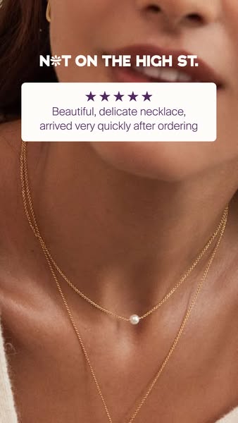 Image ad featuring a woman wearing a double layered gold necklace with a small white pearl on one of the chains. A custo