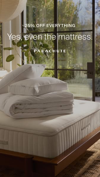 A lifestyle ad promoting Parachute bedding. The ad is composed of a bedroom set with a mattress, pillows, and comforter.