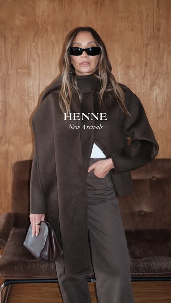 This image ad features a woman in a full-body shot wearing Henne apparel. She wears a monochromatic outfit that includes