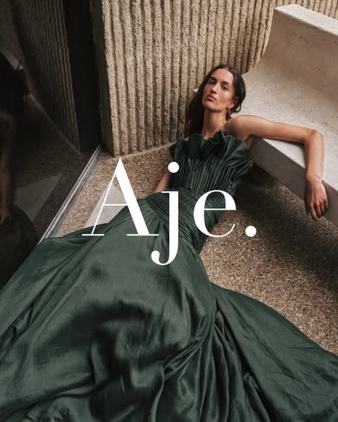 This ad for Aje. features a model reclining in a green gown, with the brand logo overlaid in the center.