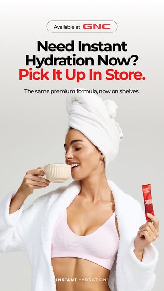 This image ad promotes an instant hydration product available at GNC, featuring a woman in a robe and towel enjoying a d